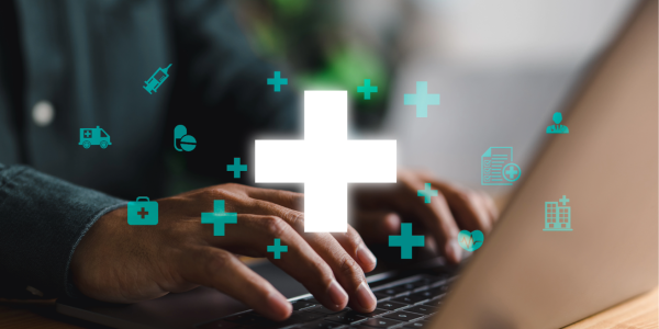 medical symbols over man at laptop